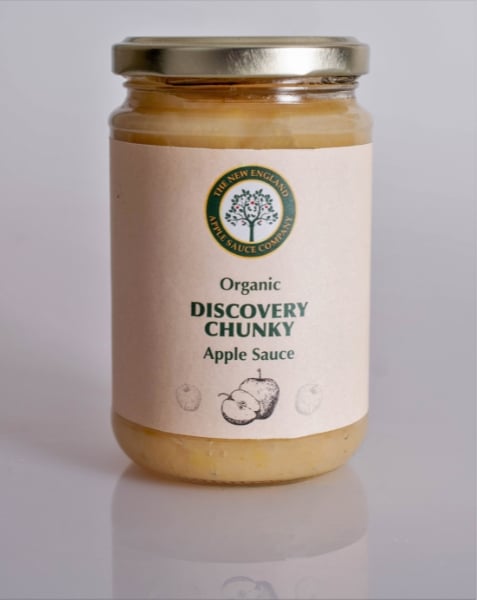 jar of discovery chunky apple sauce on a shiny surface with the label reflected beneath