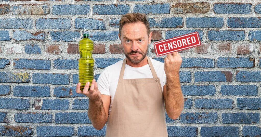 chef with an angry look on his face and his middle finger stuck up. A censored sign covering his finger
