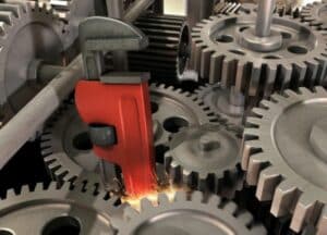 Red pipe wrench stuck in the gears of a machine. Signifying the impact of stress and your gut health